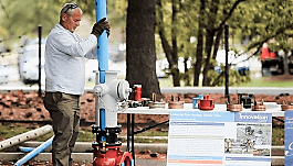 WSSC's Terry Hartle demonstrates fire hydrant tool.