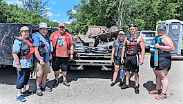 Taylor Hopper and family pose with some of the day’s haul from Iowa Project AWARE